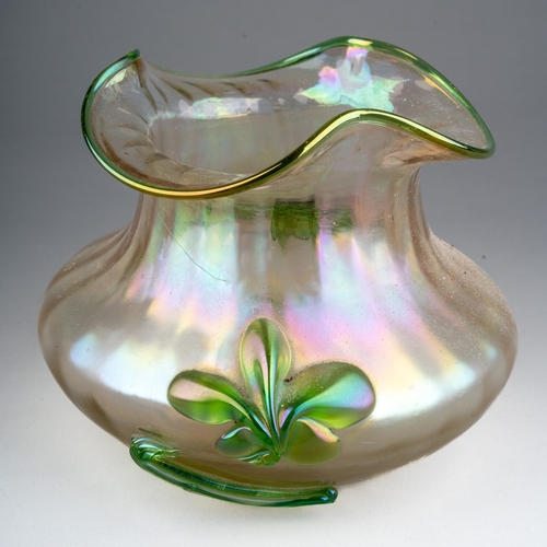 291 - An early 20th century Loetz style iridescent glass vase of squat ribbed form, green rim and applied ... 