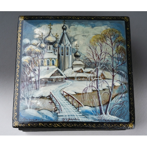 302 - A late 20th century Russian square lacquer box, painted to the hinged lid with a snowy landscape, be... 