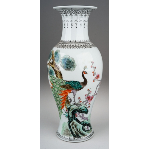 309 - A modern Chinese porcelain baluster vase, decorated with a peacock amongst branches, verse to the re... 