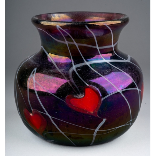 311 - A John Ditchfield iridescent glass squat baluster vase, the plum coloured glass with five red hearts... 