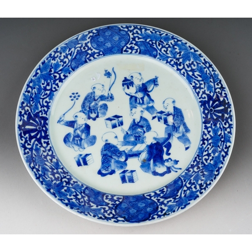 313 - A Chinese porcelain blue white plate, foliate border surrounding seven children in a variety of pose... 