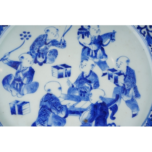 313 - A Chinese porcelain blue white plate, foliate border surrounding seven children in a variety of pose... 