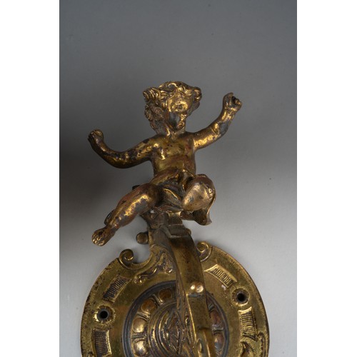 316 - A late 19th century bronze bell and wall hanging bracket, ornately cast with cherubs and scrolls, wi... 