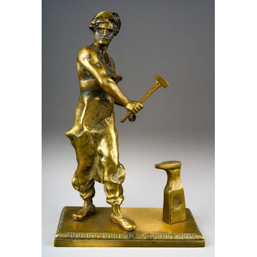 319 - A second half 20th century solid brass figure of a blacksmith standing beside an anvil, on a rectang... 