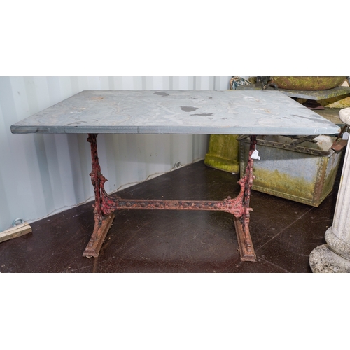 471 - A Victorian cast iron trestle table with rectangular slate top, the base cast with scrolls and raise... 