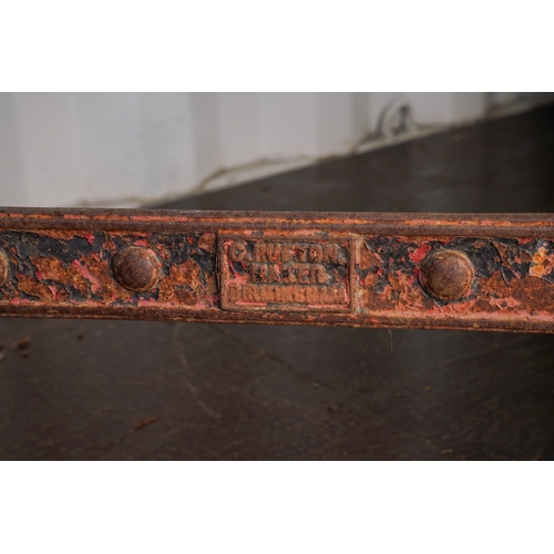 471 - A Victorian cast iron trestle table with rectangular slate top, the base cast with scrolls and raise... 