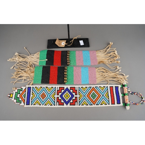 495 - Ethnographica - two tribal pairs of vintage Zulu beaded anklets with display stand