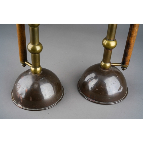 520 - A pair of Dr Christopher Dresser style copper and brass candlesticks, 20 cm high