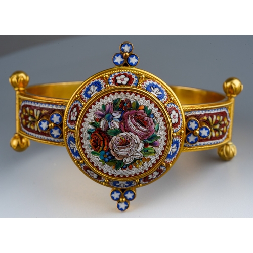 An antique micro mosaic bangle high carat gold gilt on gold base ( tests as 14-18 ct)The foliate designed front with rope twist and bead accents to the similarly designed sides, concealed screw thread clasp, inner diameter 60mm, gross weight 40.0 grams.