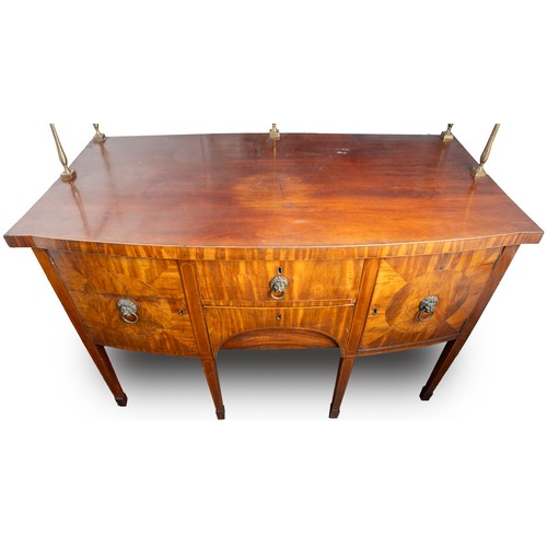 882 - An early 19th century mahogany and satinwood strung sideboard, brass rail back with five urn finials... 