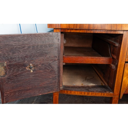 882 - An early 19th century mahogany and satinwood strung sideboard, brass rail back with five urn finials... 