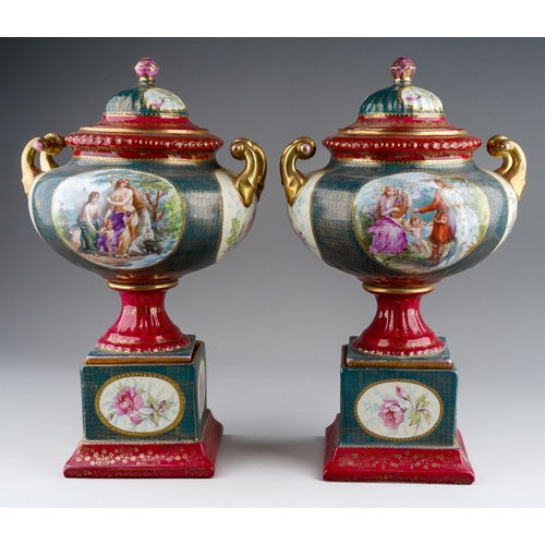 886 - A pair of early 20th Century Continental Vienna style pedestal two handled urns and covers, painted ... 