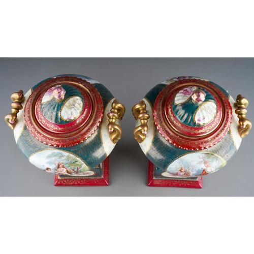 886 - A pair of early 20th Century Continental Vienna style pedestal two handled urns and covers, painted ... 