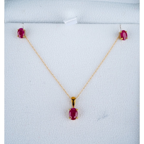 1126 - A 9ct gold pendant and earring set. The pendant and earrings set with glass filled rubies, hallmarke... 