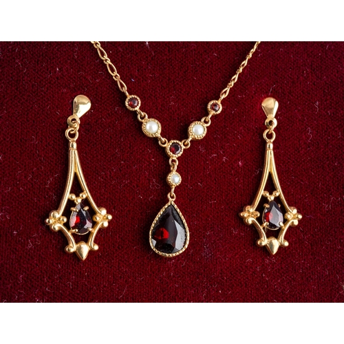 1127 - 9 ct gold set of earrings and matching necklace set with red gem stones and seed pearls, in their or... 