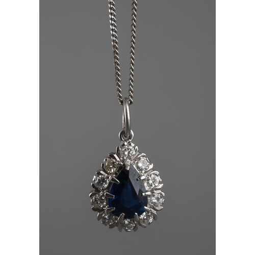 1128 - An 18ct gold sapphire and diamond cluster pendant, with 9ct gold chain. The pendant set with a pear ... 