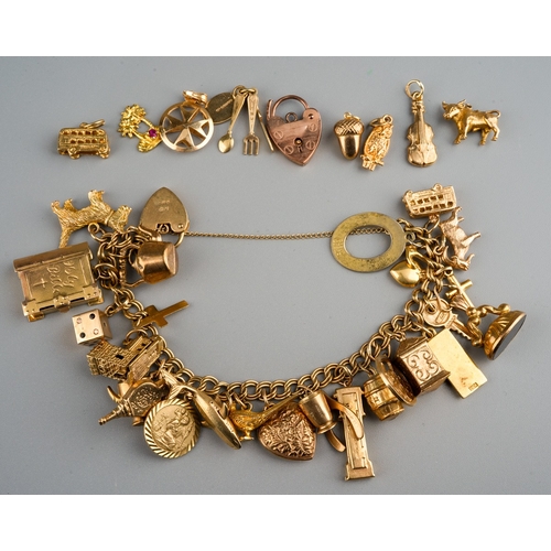 1133 - 9 ct gold charm bracelet together with loose charms, gross weight 58g