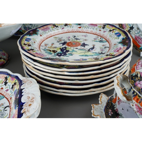 24 - A Mason`s Patent Ironstone China part Imari dinner service,  the central section with exotic birds a... 