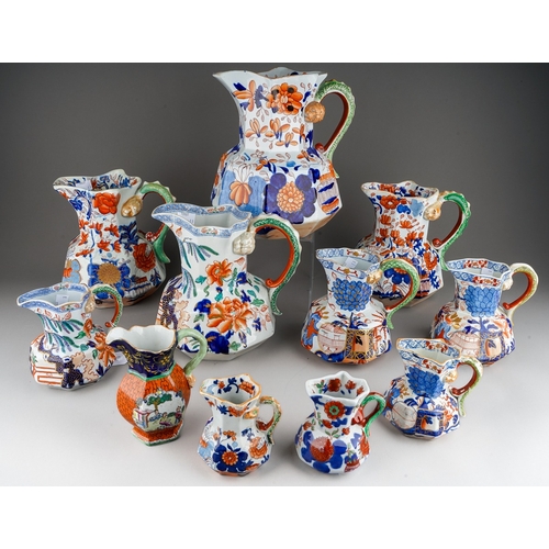 29 - Three 19th Century Imari Mason`s Ironstone graduating jugs, serpent handles with Lions head terminal... 