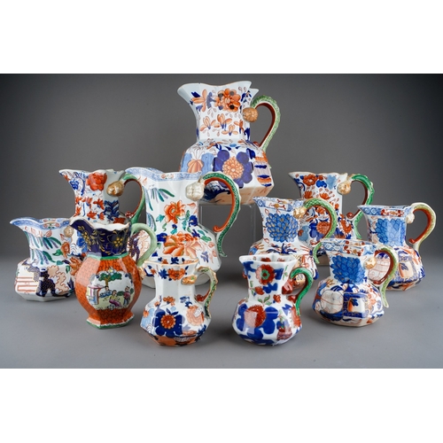 29 - Three 19th Century Imari Mason`s Ironstone graduating jugs, serpent handles with Lions head terminal... 