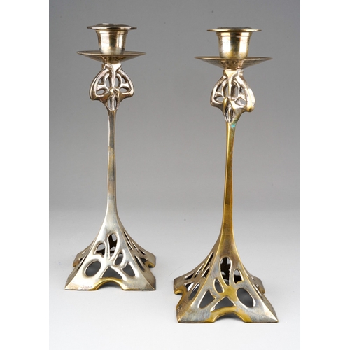 38 - A pair of Art Nouveau EPNS candlesticks in the manner of WMF with openwork stands, detachable scones... 