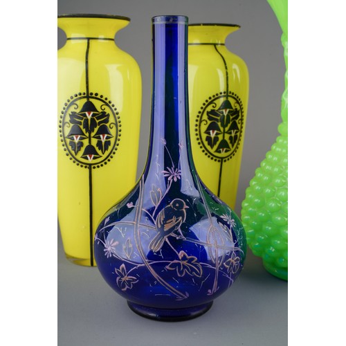 61 - Collection of Victorian glass to include a pair of black enamel vases, yellow vases and large green ... 