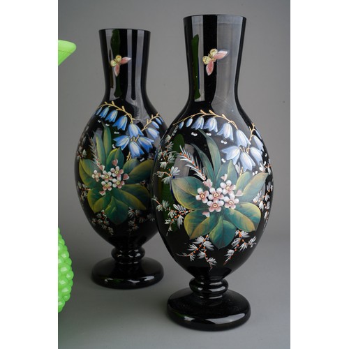 61 - Collection of Victorian glass to include a pair of black enamel vases, yellow vases and large green ... 