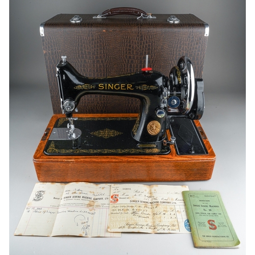 403 - A cased Singer manual sewing machine, serial number EC561247, circa 1939, the case fitted with oil c... 