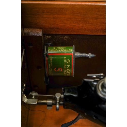 403 - A cased Singer manual sewing machine, serial number EC561247, circa 1939, the case fitted with oil c... 