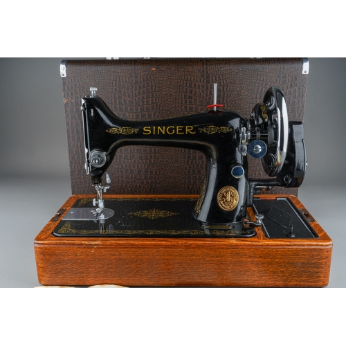 403 - A cased Singer manual sewing machine, serial number EC561247, circa 1939, the case fitted with oil c... 