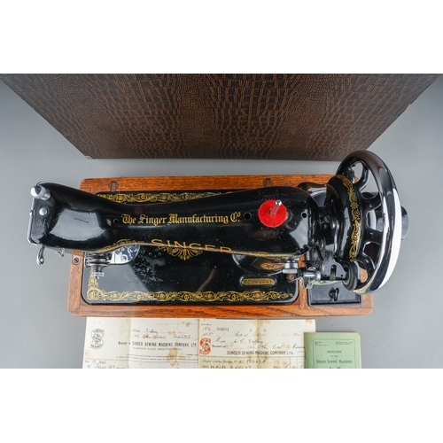 403 - A cased Singer manual sewing machine, serial number EC561247, circa 1939, the case fitted with oil c... 