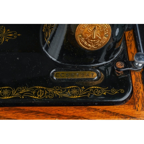 403 - A cased Singer manual sewing machine, serial number EC561247, circa 1939, the case fitted with oil c... 