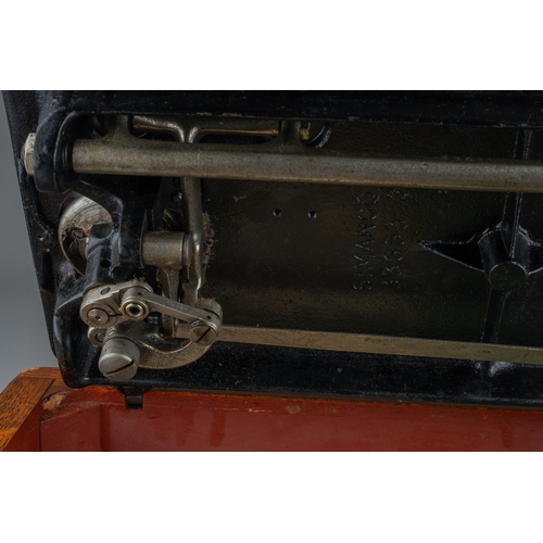 403 - A cased Singer manual sewing machine, serial number EC561247, circa 1939, the case fitted with oil c... 