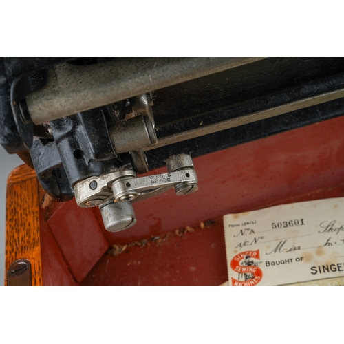 403 - A cased Singer manual sewing machine, serial number EC561247, circa 1939, the case fitted with oil c... 