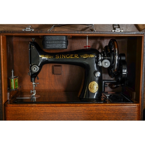 403 - A cased Singer manual sewing machine, serial number EC561247, circa 1939, the case fitted with oil c... 