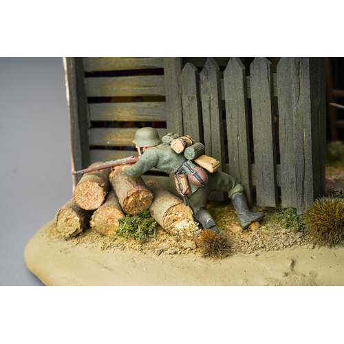 409 - A 21st century scale model World War II diorama of German troops with panzer tank by a barn with tro... 