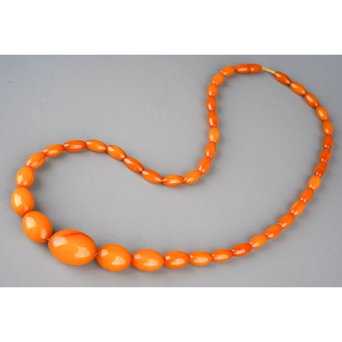 523 - A reconstituted amber necklace, gross weight 32.48 grams.