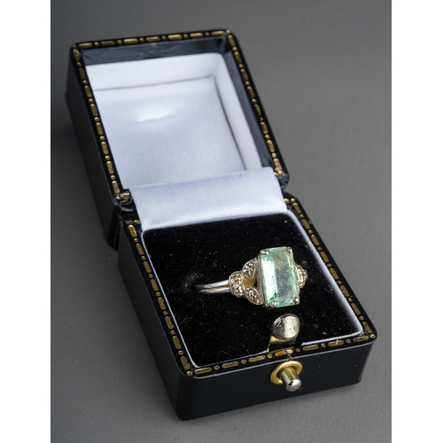 536 - An 18ct white gold dress ring, set with a pale green gem stone, possibly tourmaline, UK ring size P,... 