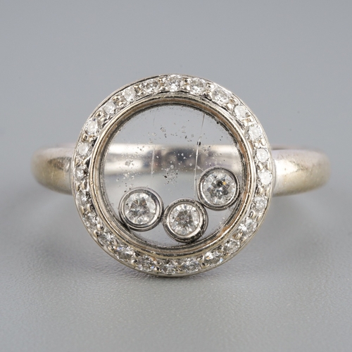 585 - A 18k diamond ring with floating diamonds, weight 3.77 grams.