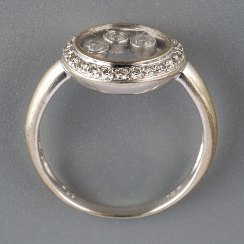 585 - A 18k diamond ring with floating diamonds, weight 3.77 grams.