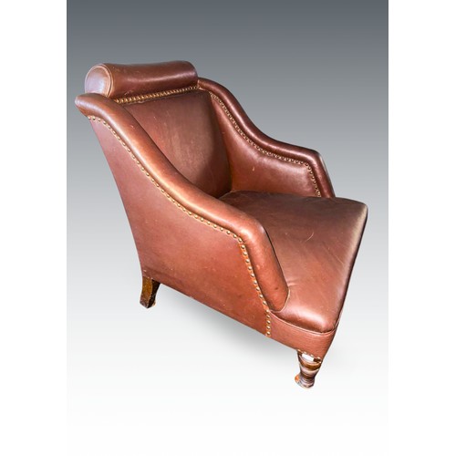 958 - A Victorian brown rexine upholstered easy chair, bolster style headrest, sloped arms, on walnut legs... 