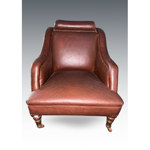 958 - A Victorian brown rexine upholstered easy chair, bolster style headrest, sloped arms, on walnut legs... 