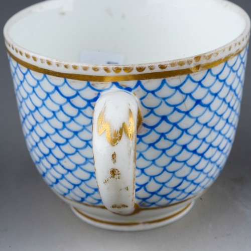 332 - A 19th century Sevres porcelain coffee cup, blue fish scale design with vignette of an exotic bird s... 