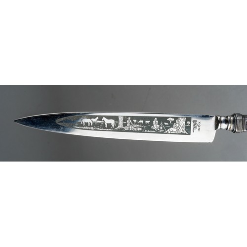 334 - A late 20th century Argentinian Inox white metal Gaucho knife with matching sheath, cast with cattle... 