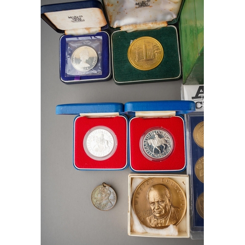 721 - Coins and medallions, A tin box containing a collection of Royal Mint commemorative crowns and other... 