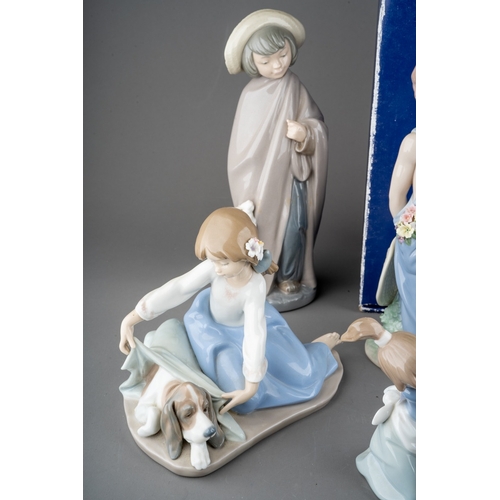 12 - Five Lladro figures, four loose, one boxed to include: 
1. Girl with flowers, no 5604
2. Dog`s Best ... 