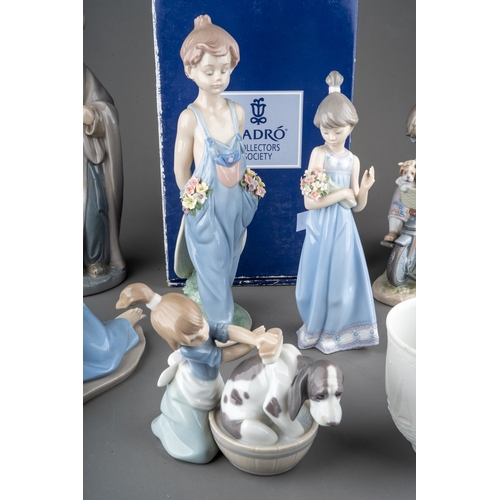 12 - Five Lladro figures, four loose, one boxed to include: 
1. Girl with flowers, no 5604
2. Dog`s Best ... 