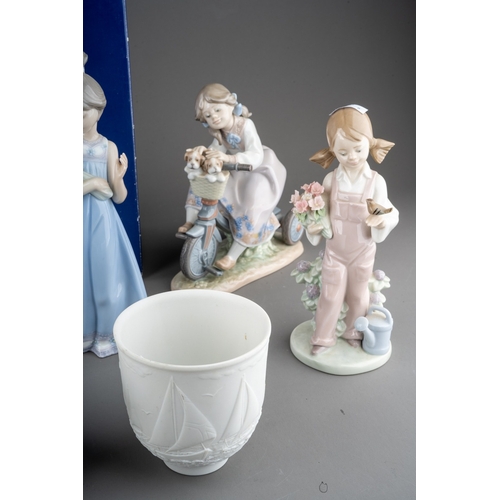 12 - Five Lladro figures, four loose, one boxed to include: 
1. Girl with flowers, no 5604
2. Dog`s Best ... 