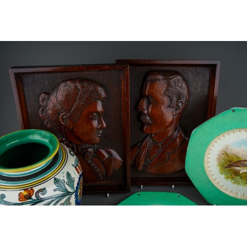 22 - A pair of early 20th Century carved wooden portrait profile plaques of a Gentleman and Lady, America... 