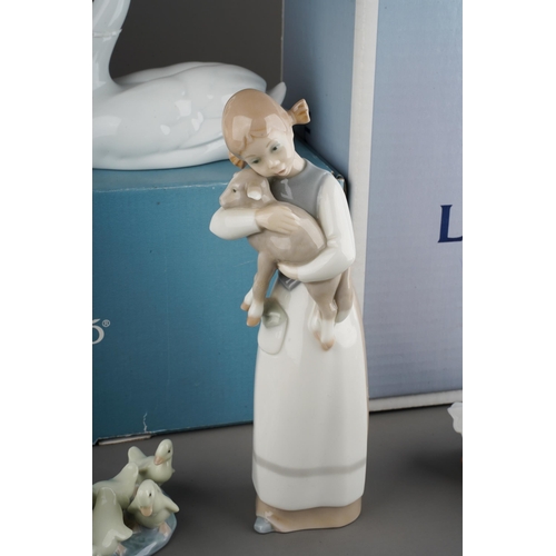 24 - Two boxed Lladro figures and three loose Lladro figures, the boxed figures comprising no.7049 